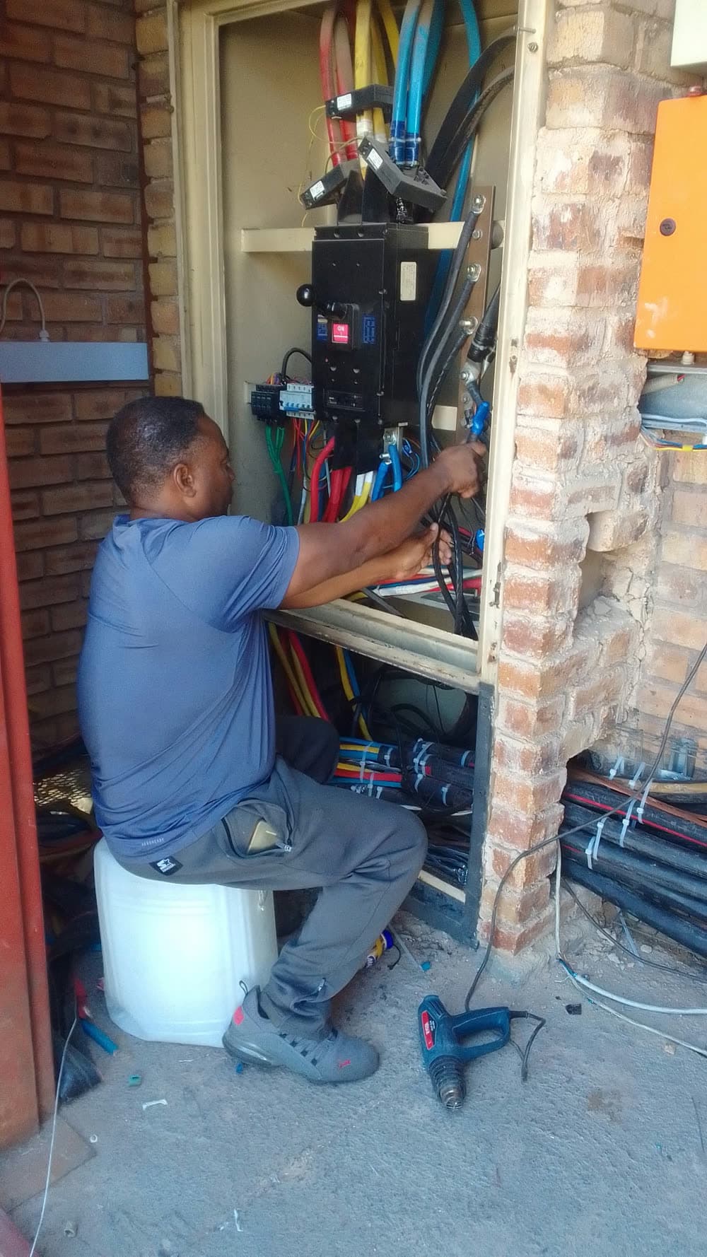 Erga electrician working on distribution board wiring
